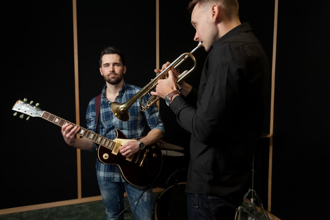Musician playing guitar on stage